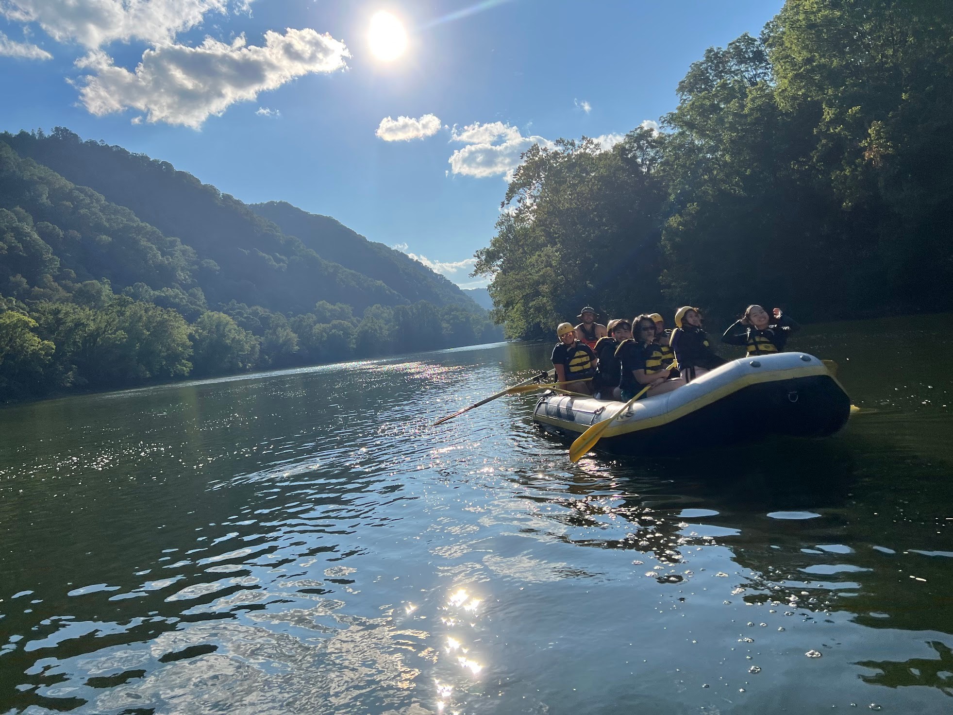 a small boat in a body of water with a mountain in the background