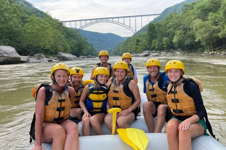 Louis Herthum et al. sitting next to a body of water