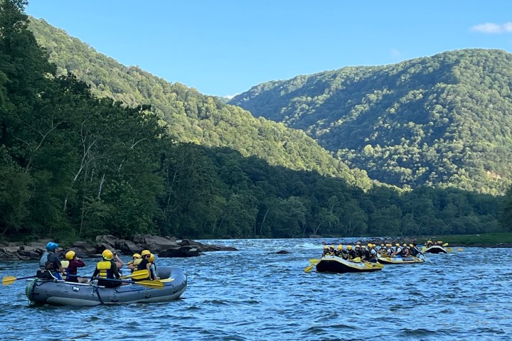 a small boat in a body of water with a mountain in the background