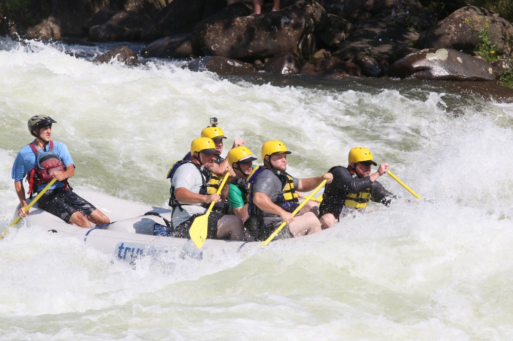 a group of people on a raft in a body of water