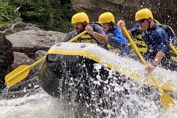 a man riding on a raft in a body of water