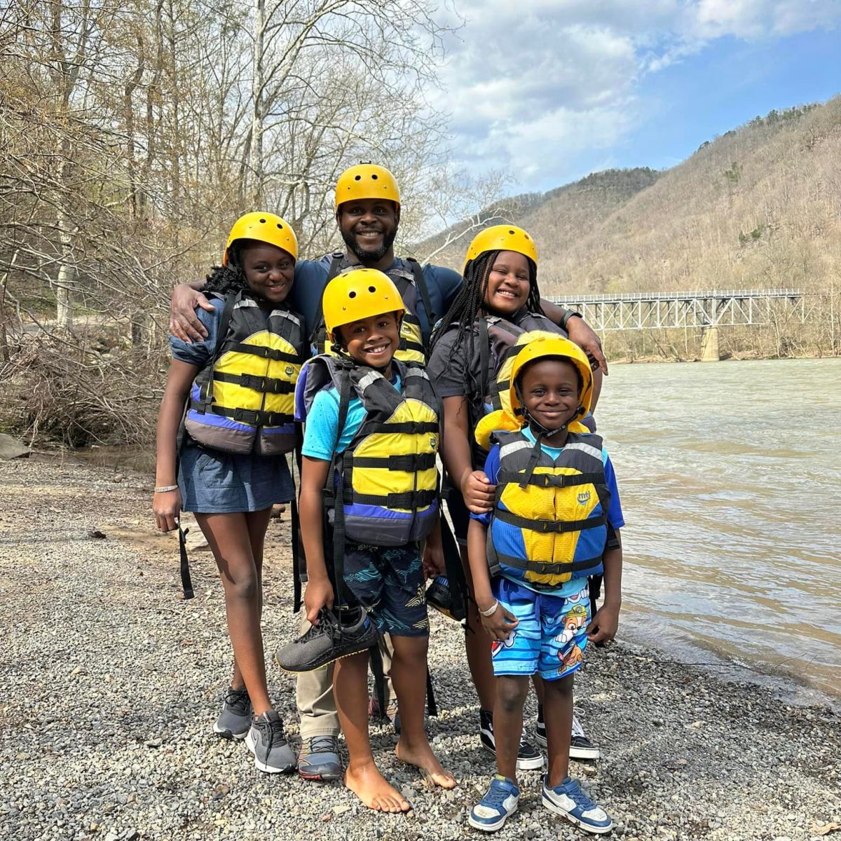 a group of people standing on a dirt road