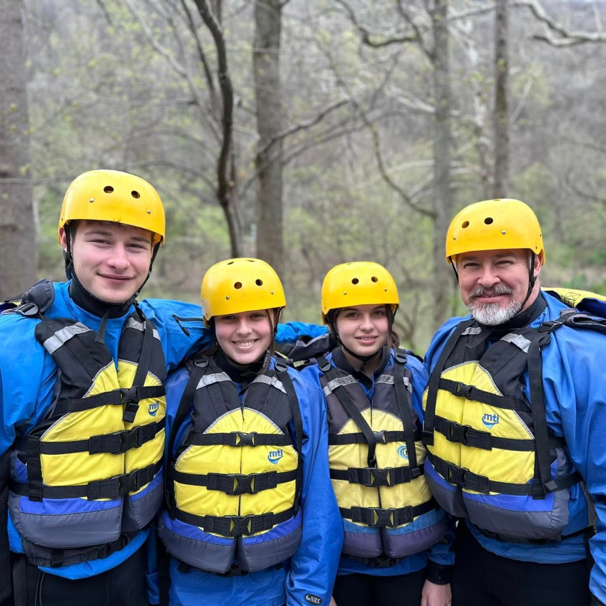 a group of people standing next to a tree