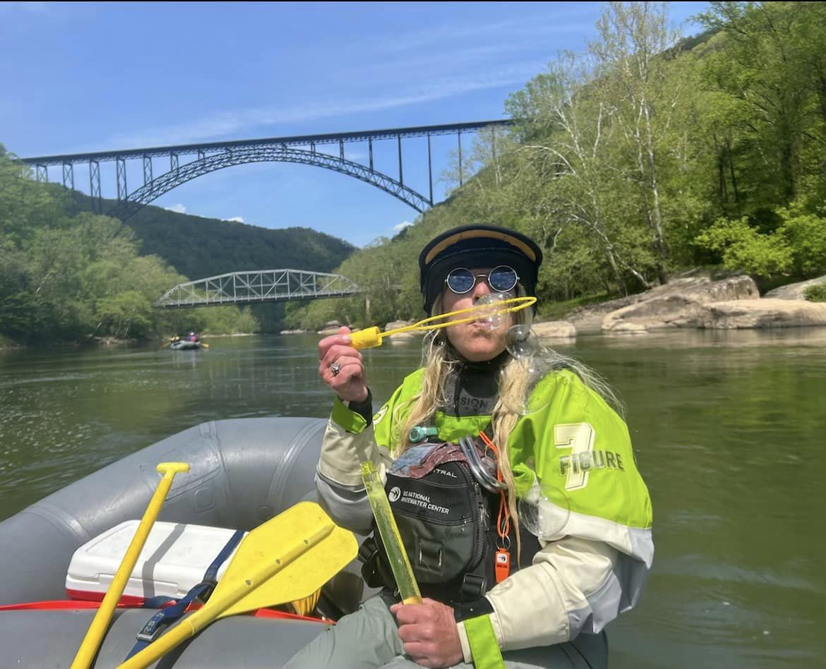 a man riding on the back of a boat in a body of water