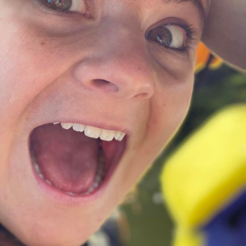 a close up of a man with a banana in his mouth