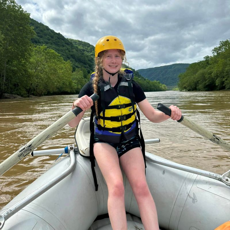 a person riding on the back of a boat