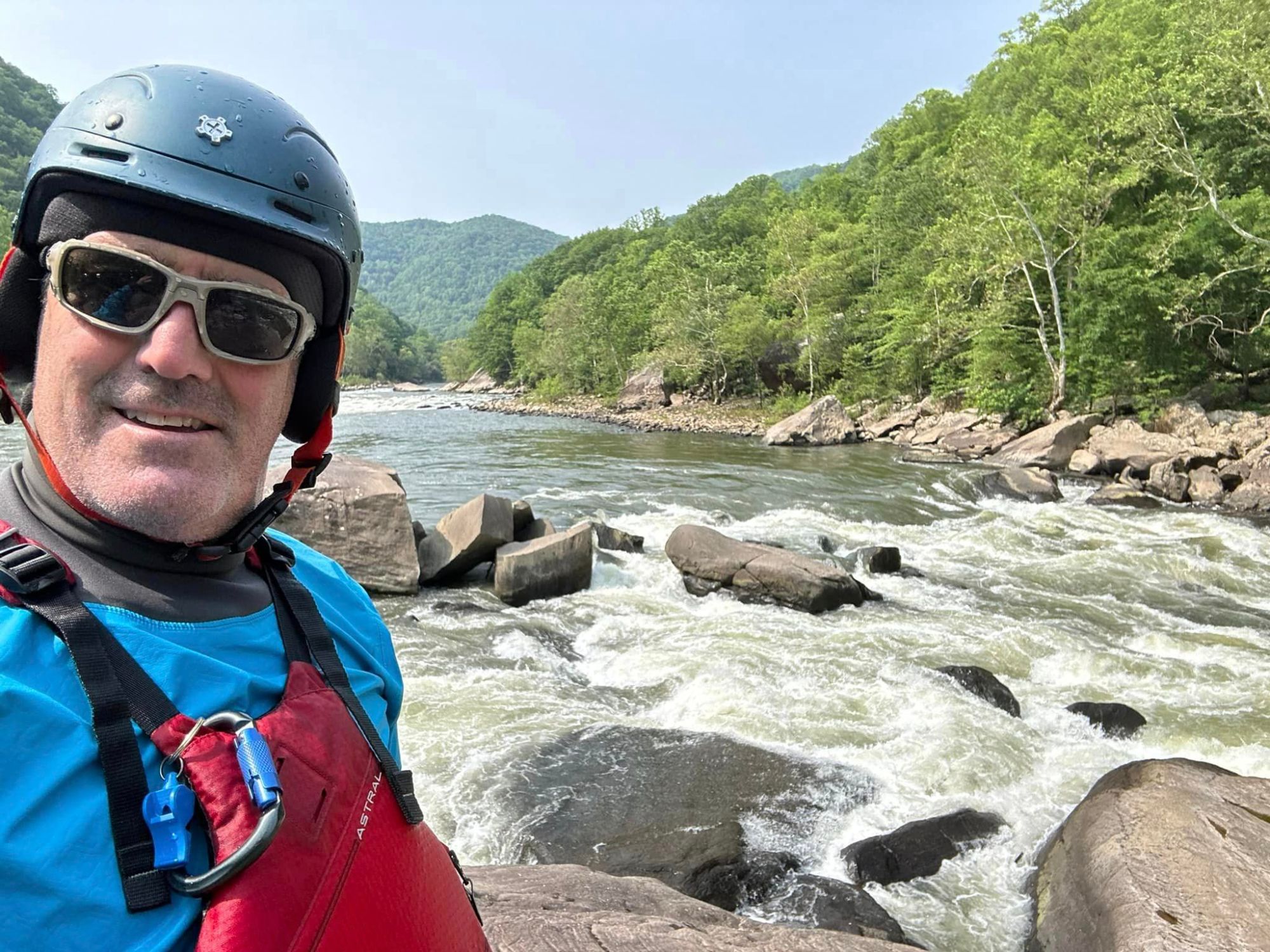 a man standing next to a river