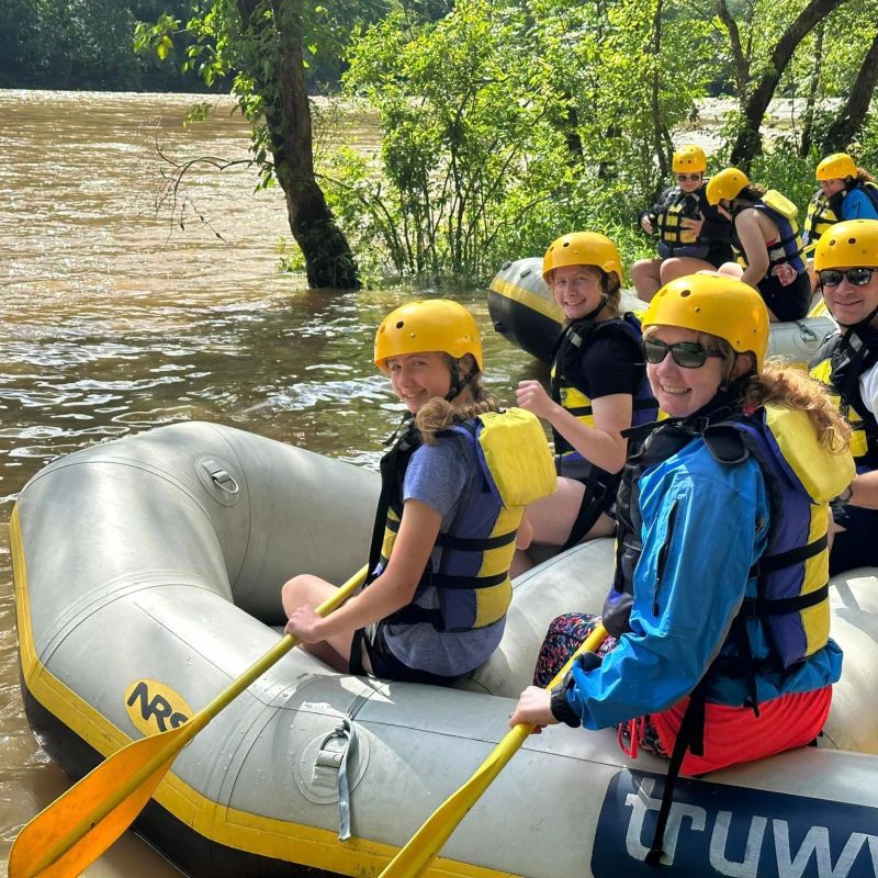 a group of people on a raft in the water