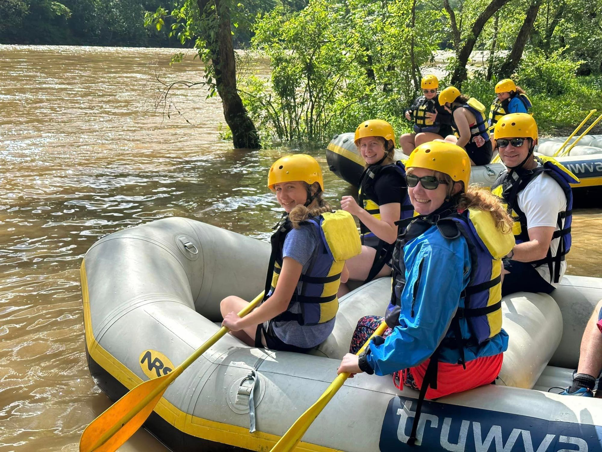 347389459_232264016178404_2298588876005600619_n a group of people on a raft in the water