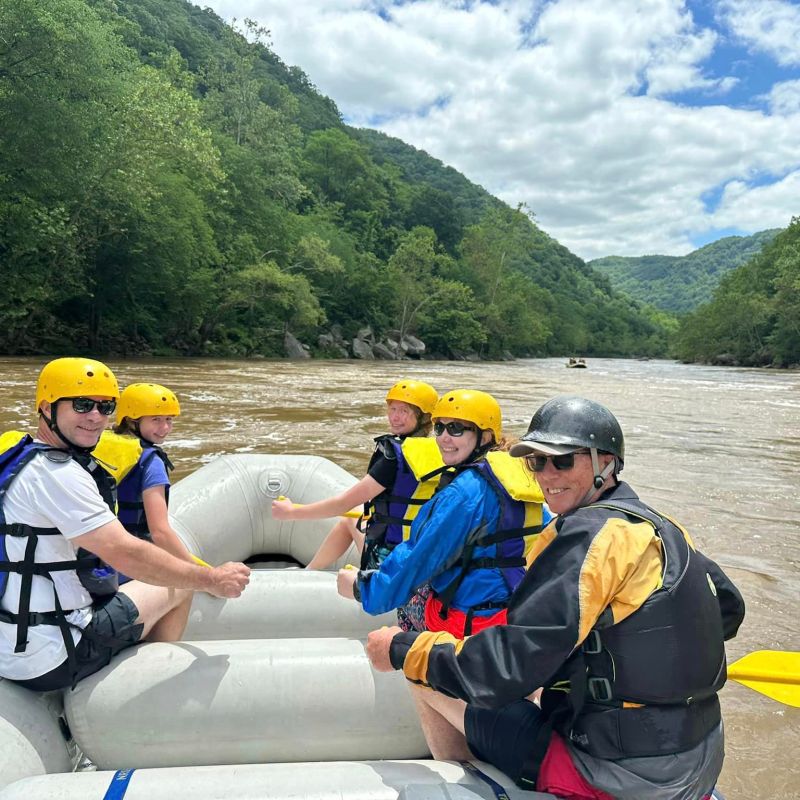 a group of people sitting on top of a mountain