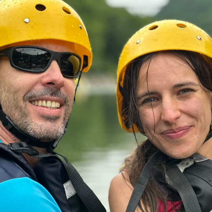 a person wearing a hat and sunglasses posing for the camera