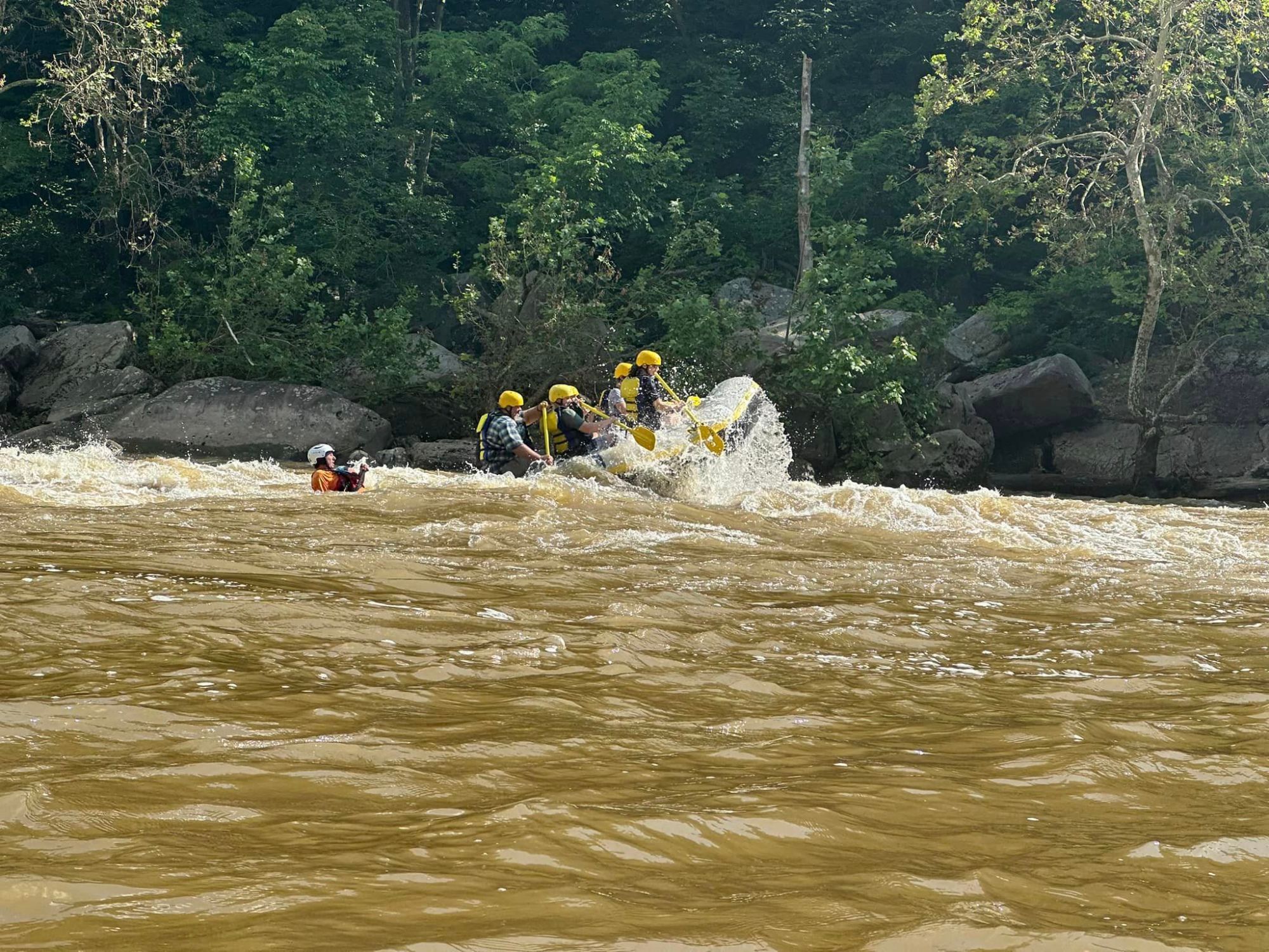 a group of people on a raft in a body of water