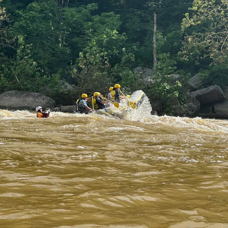 a group of people on a raft in a body of water