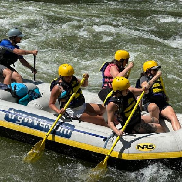 a group of people riding on a raft in a body of water