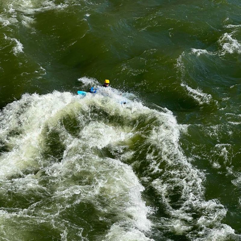 a man riding a wave on top of a body of water