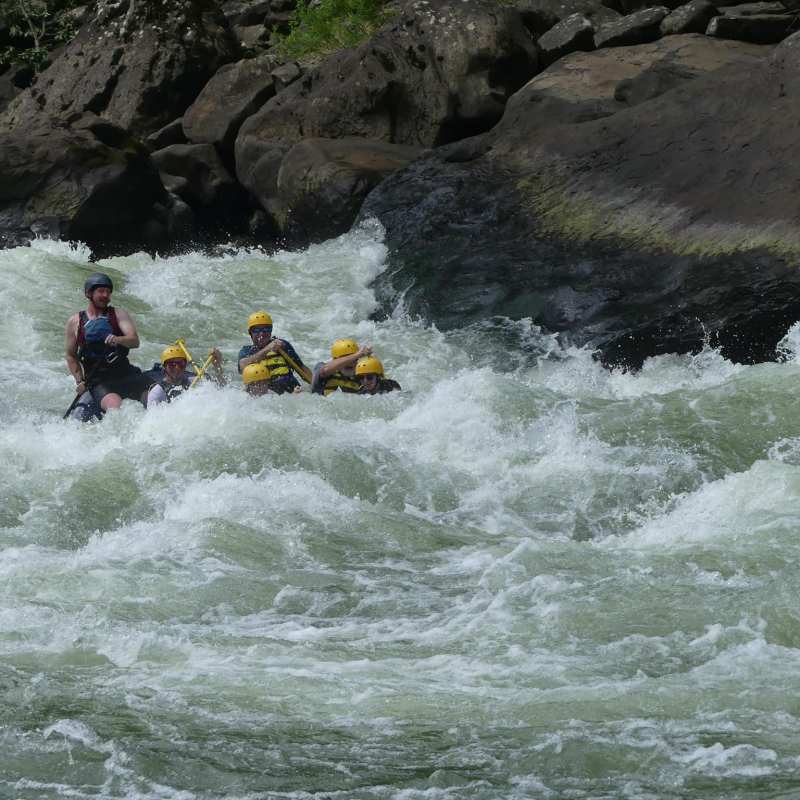 a group of people riding on a raft in a body of water