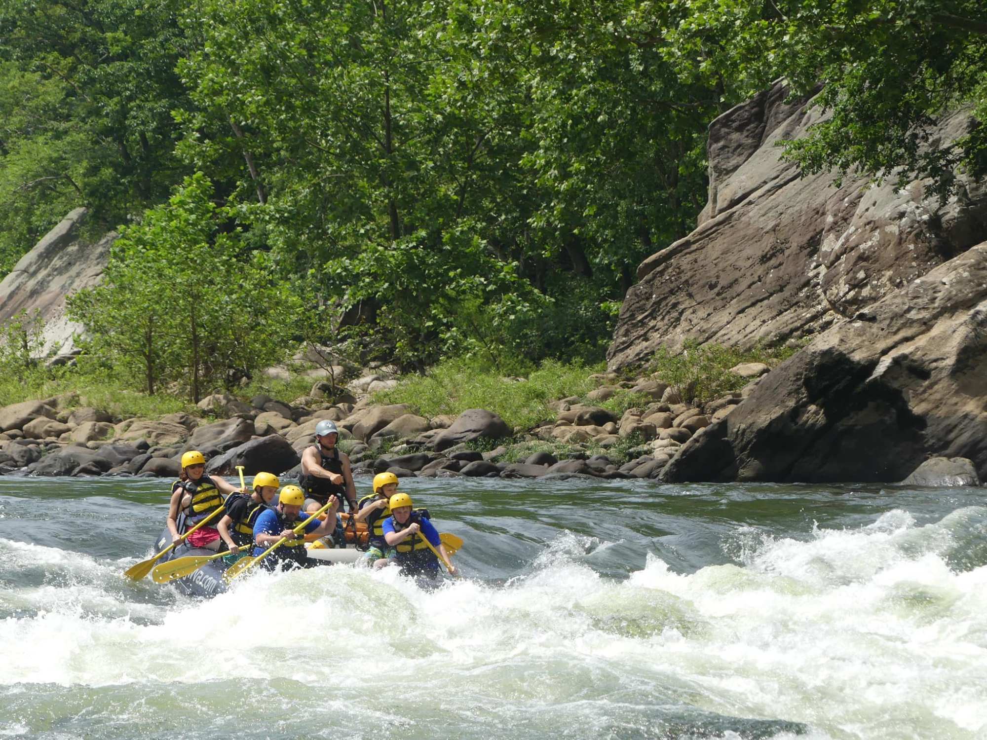 a group of people riding on a raft in a body of water