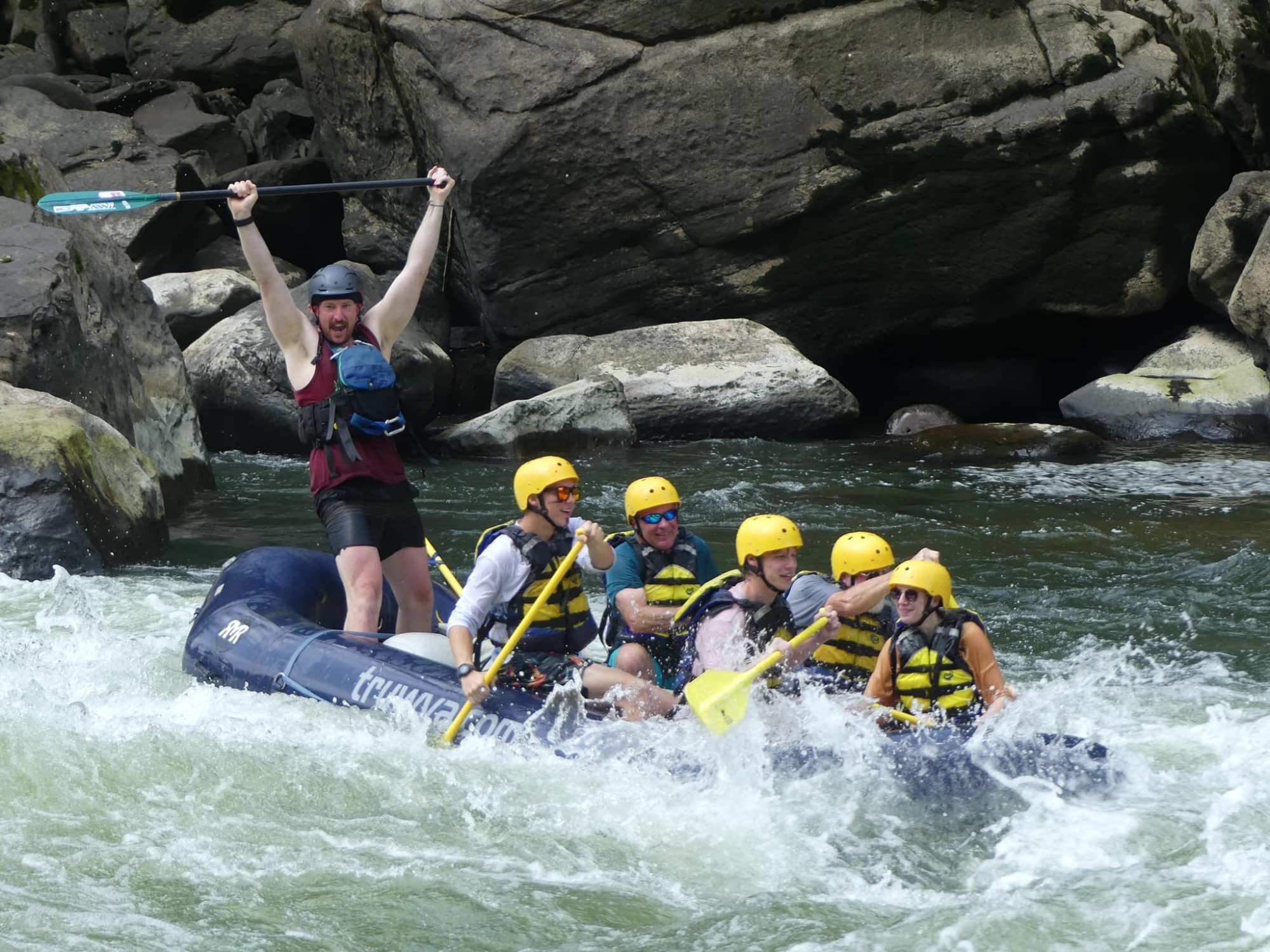 a man riding on a raft in a body of water