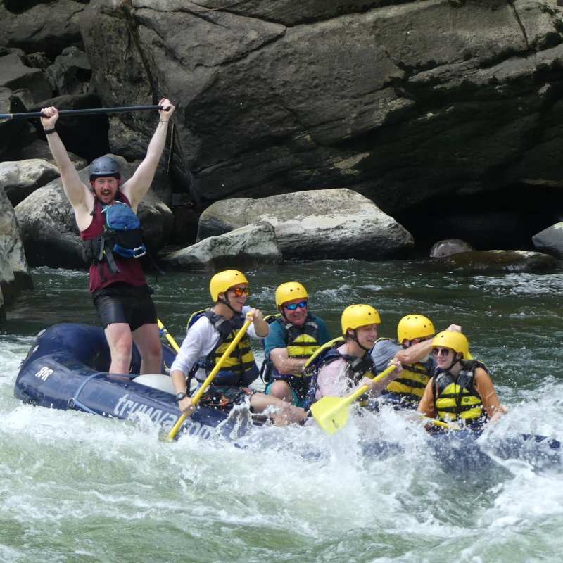 a man riding on a raft in a body of water