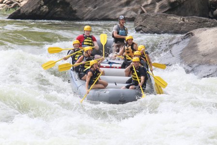 a group of people on a raft in a body of water