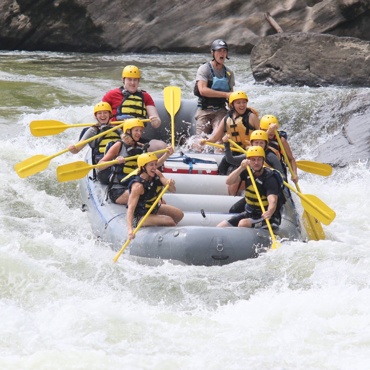 a group of people on a raft in a body of water