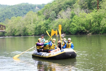 a person riding on the back of a boat in a body of water