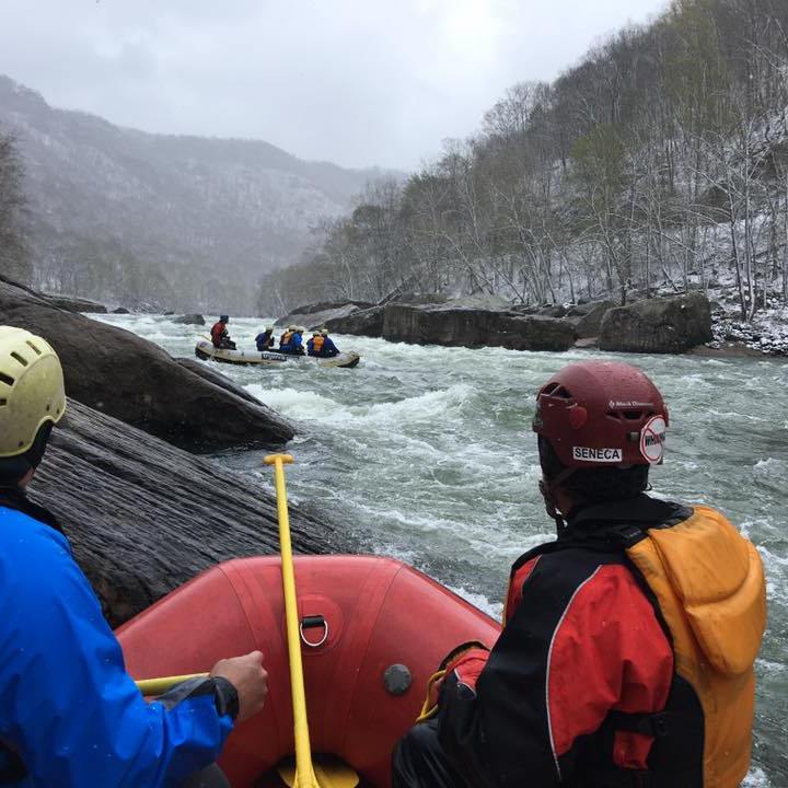 a group of baseball players standing on top of a snow covered mountain