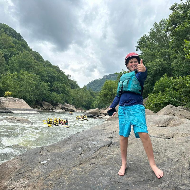 a person standing next to a tree