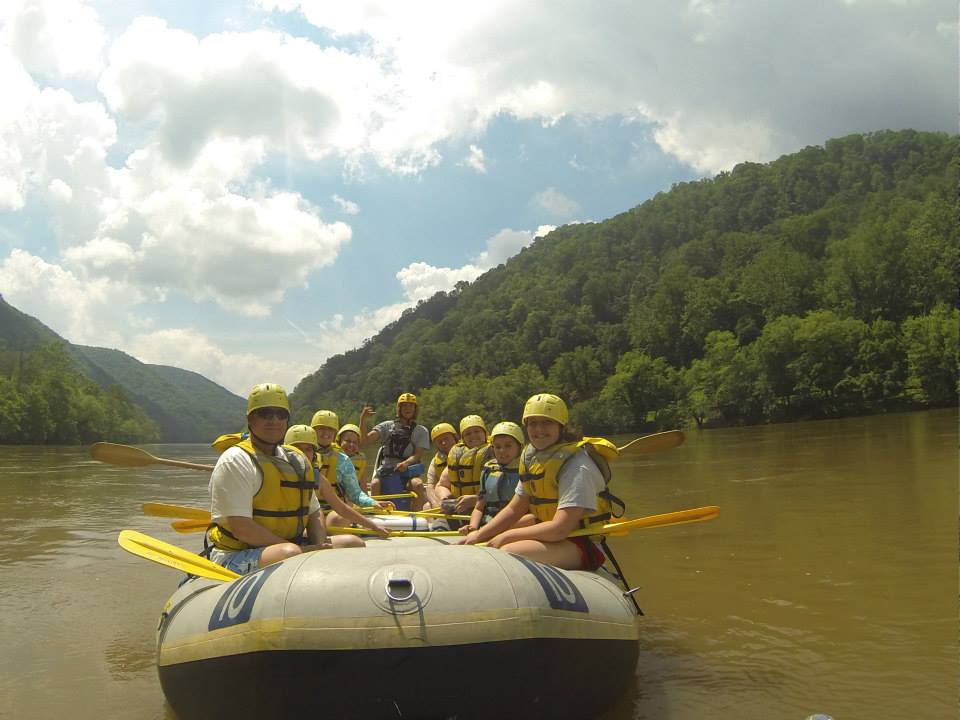 a group of people in a boat on a body of water
