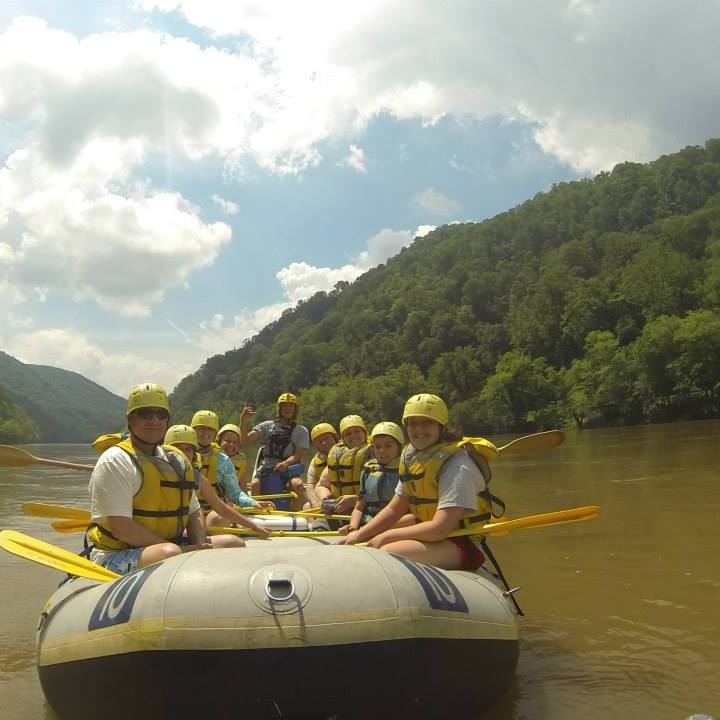 a group of people in a boat on a body of water