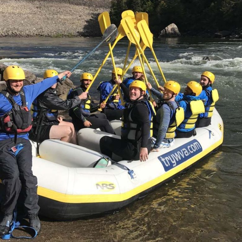 a group of people sitting on a raft