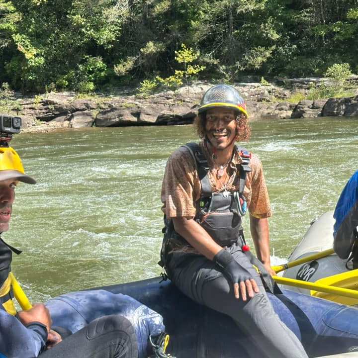 a group of people sitting on a raft