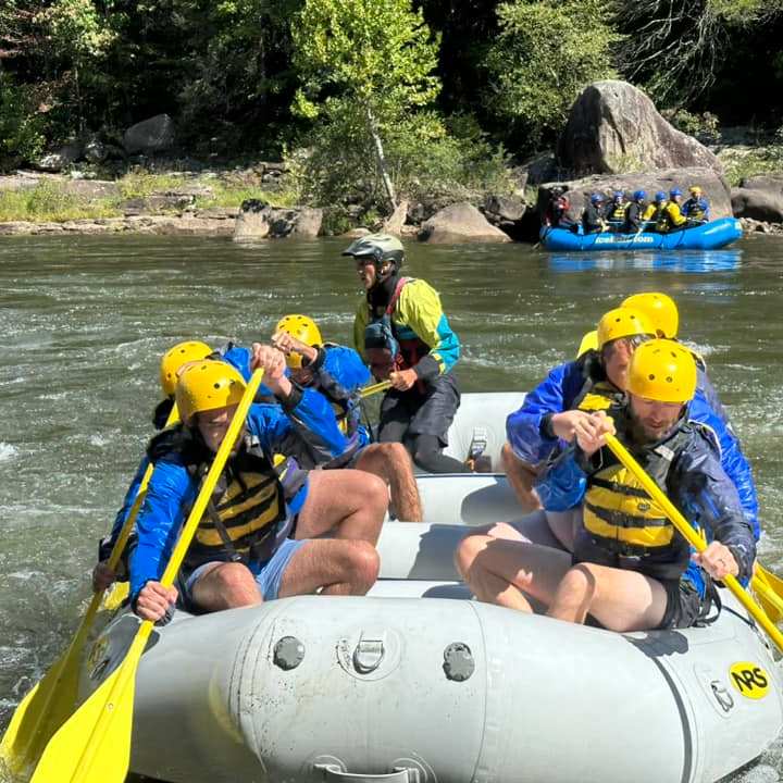a group of people on a raft in a body of water