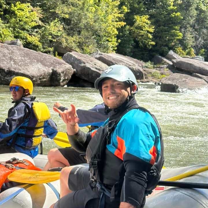 a group of people sitting on a raft