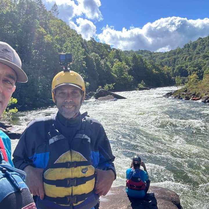 a couple of people standing on top of a mountain