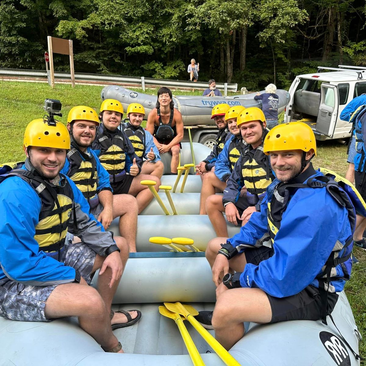 a group of people sitting on a raft