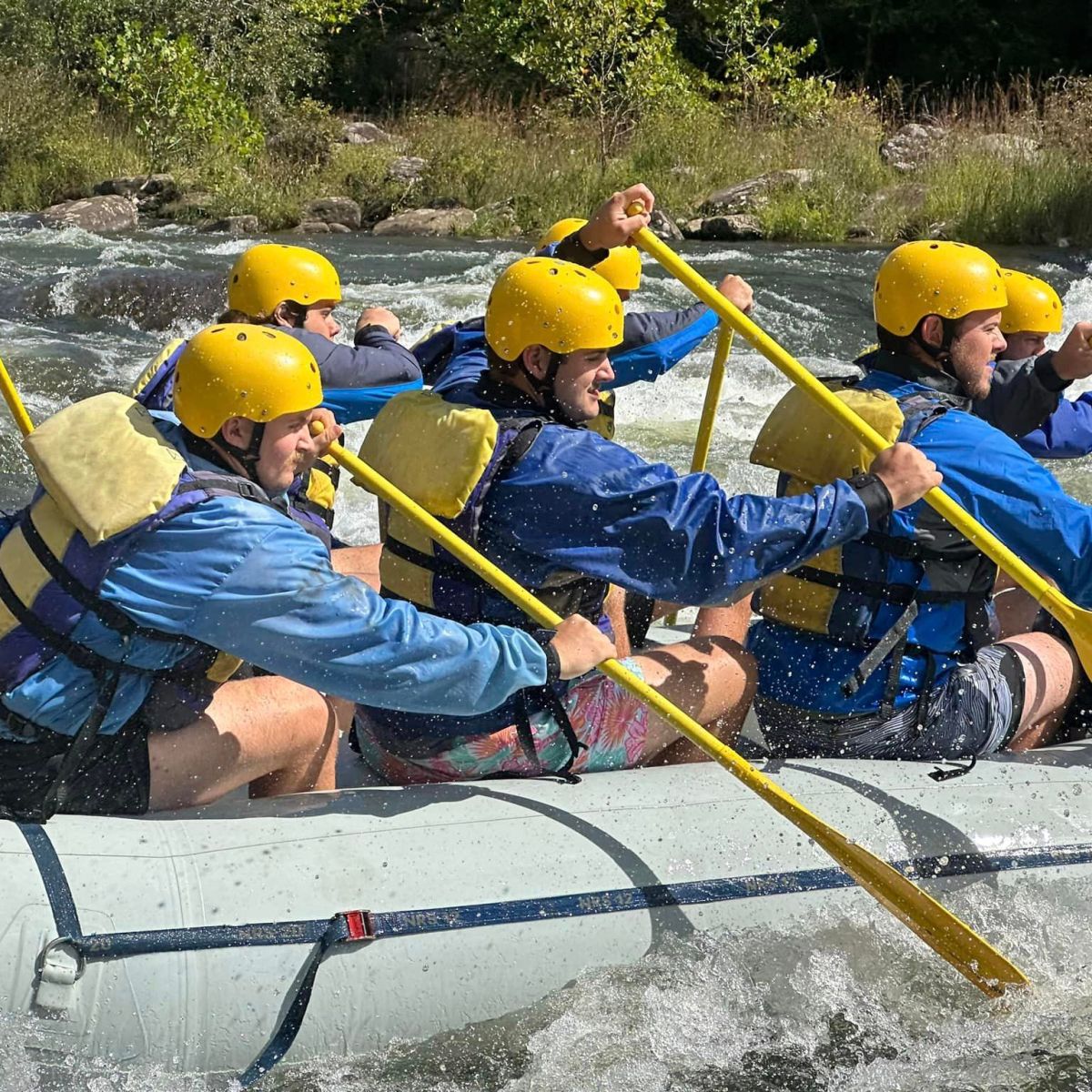a group of people sitting on a raft