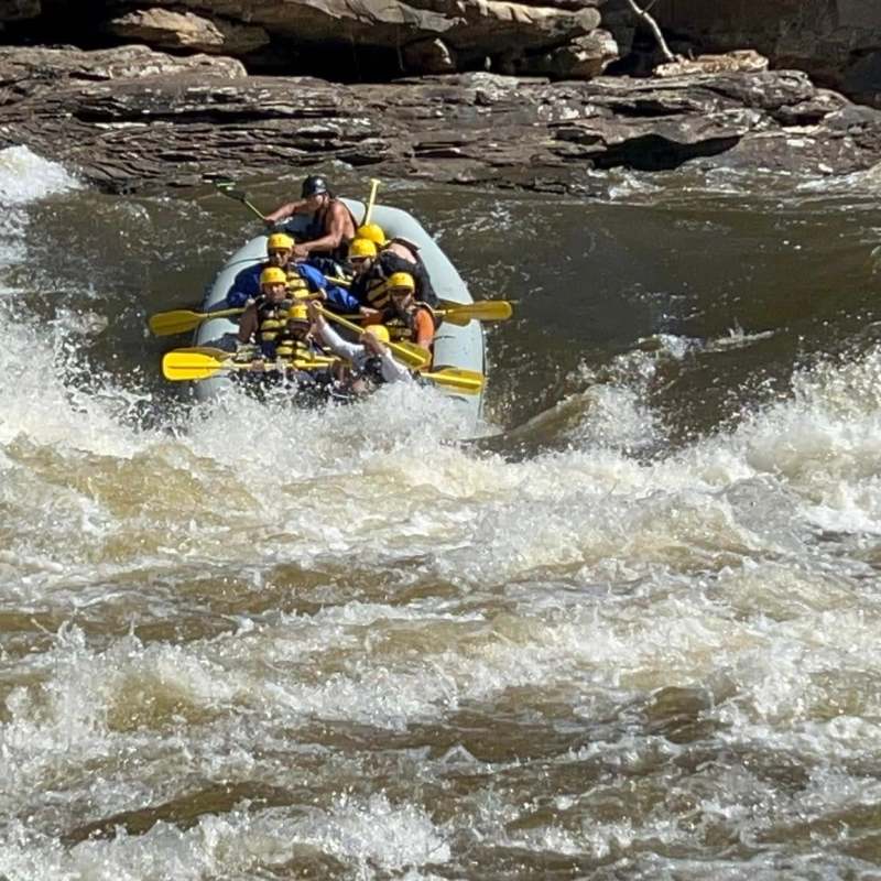 a man riding on a raft in a body of water