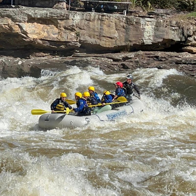 a group of people on a raft in a body of water