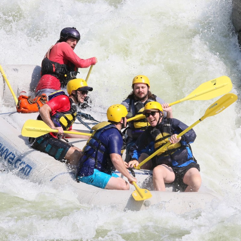 a man riding on a raft in a body of water