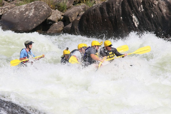 a group of people on a raft in the water