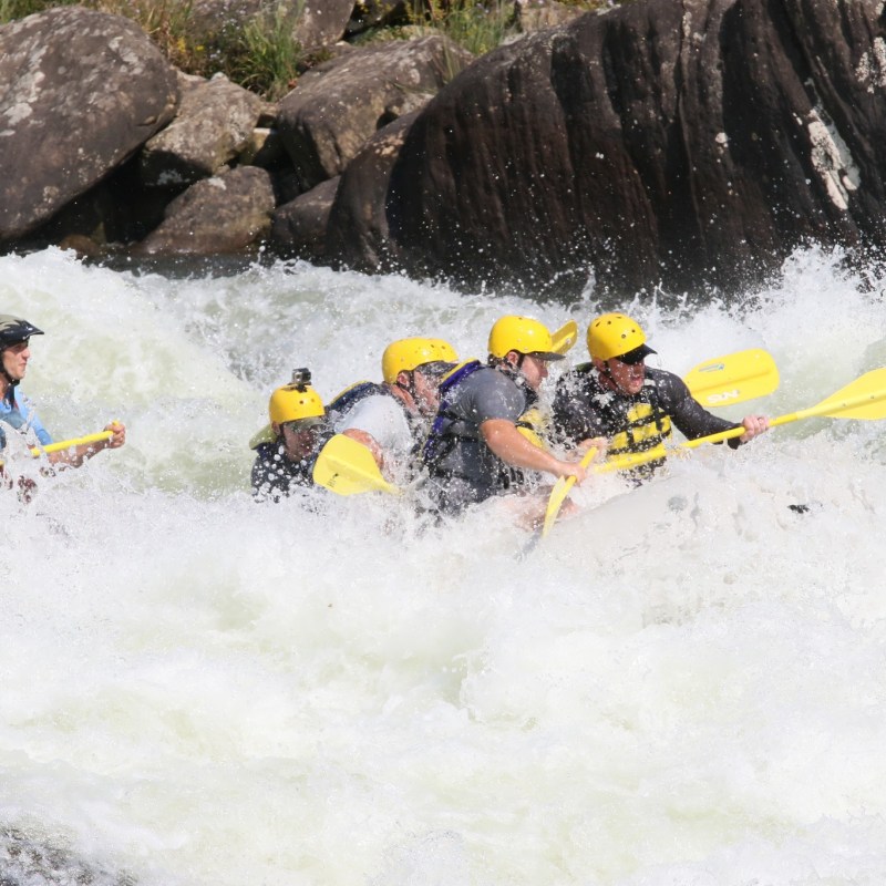 a group of people on a raft in the water