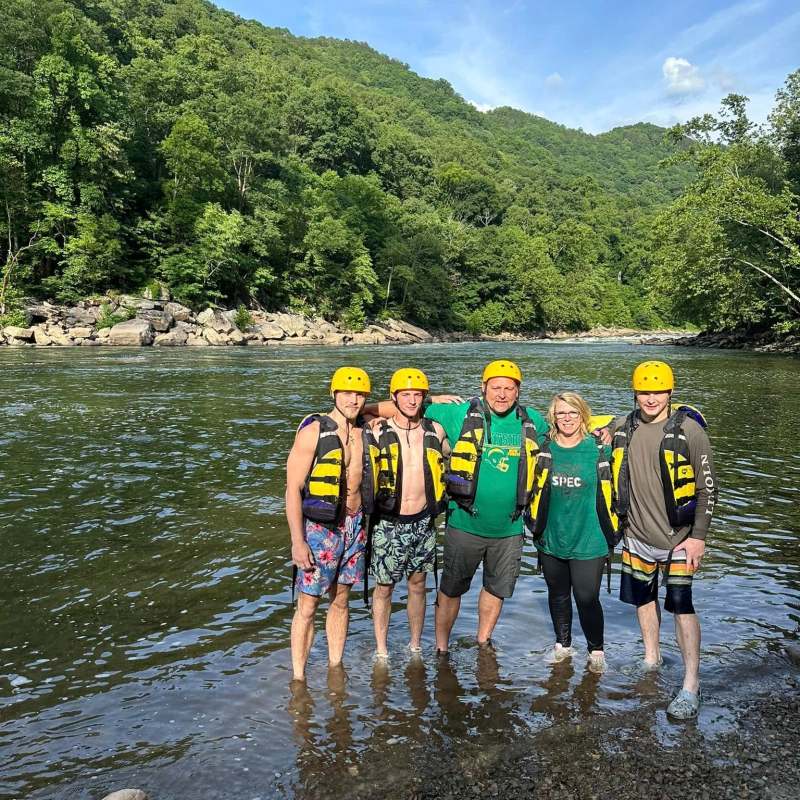a group of people standing next to a body of water