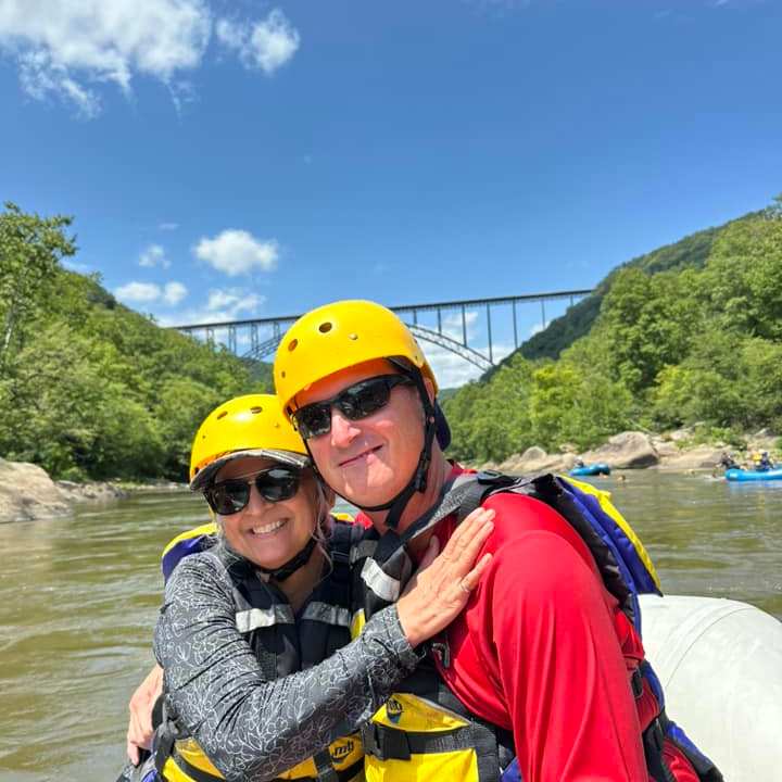 a man standing next to a body of water