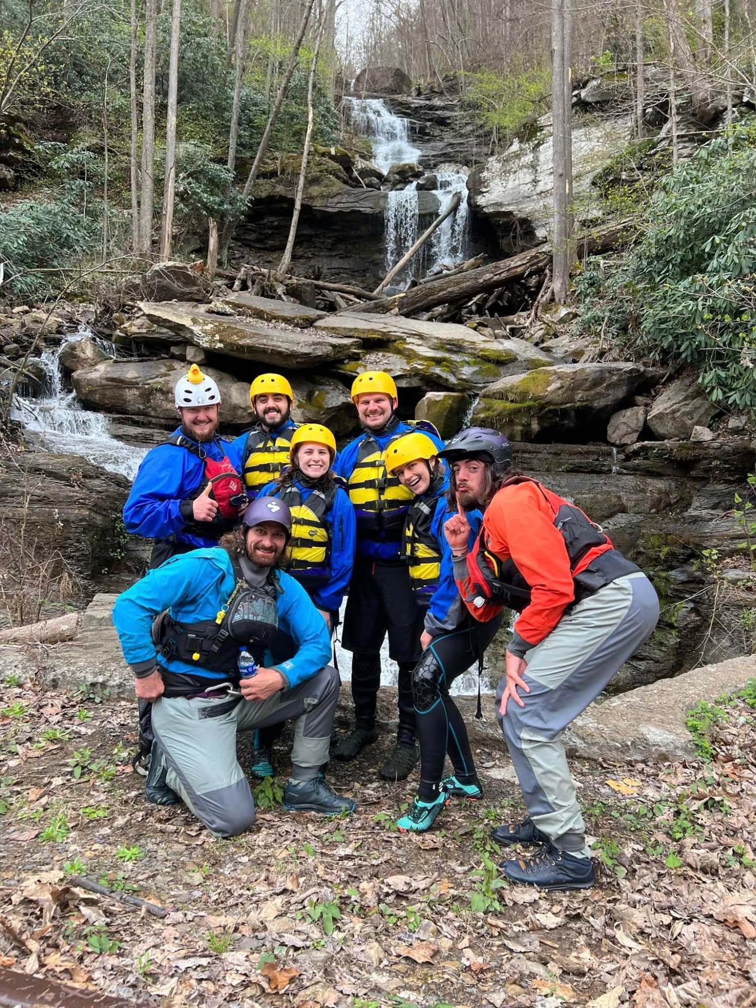 a group of people standing next to a tree