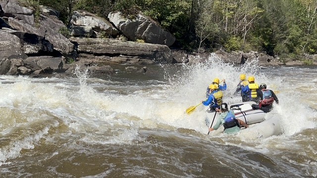 a man riding on a raft in a body of water