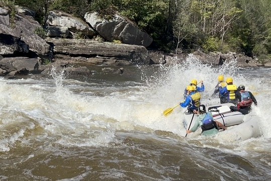 a man riding on a raft in a body of water