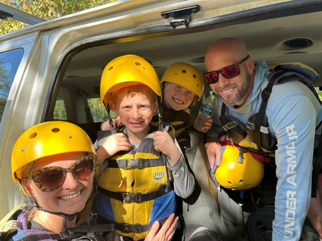 Anne Holm et al. in a car wearing a helmet