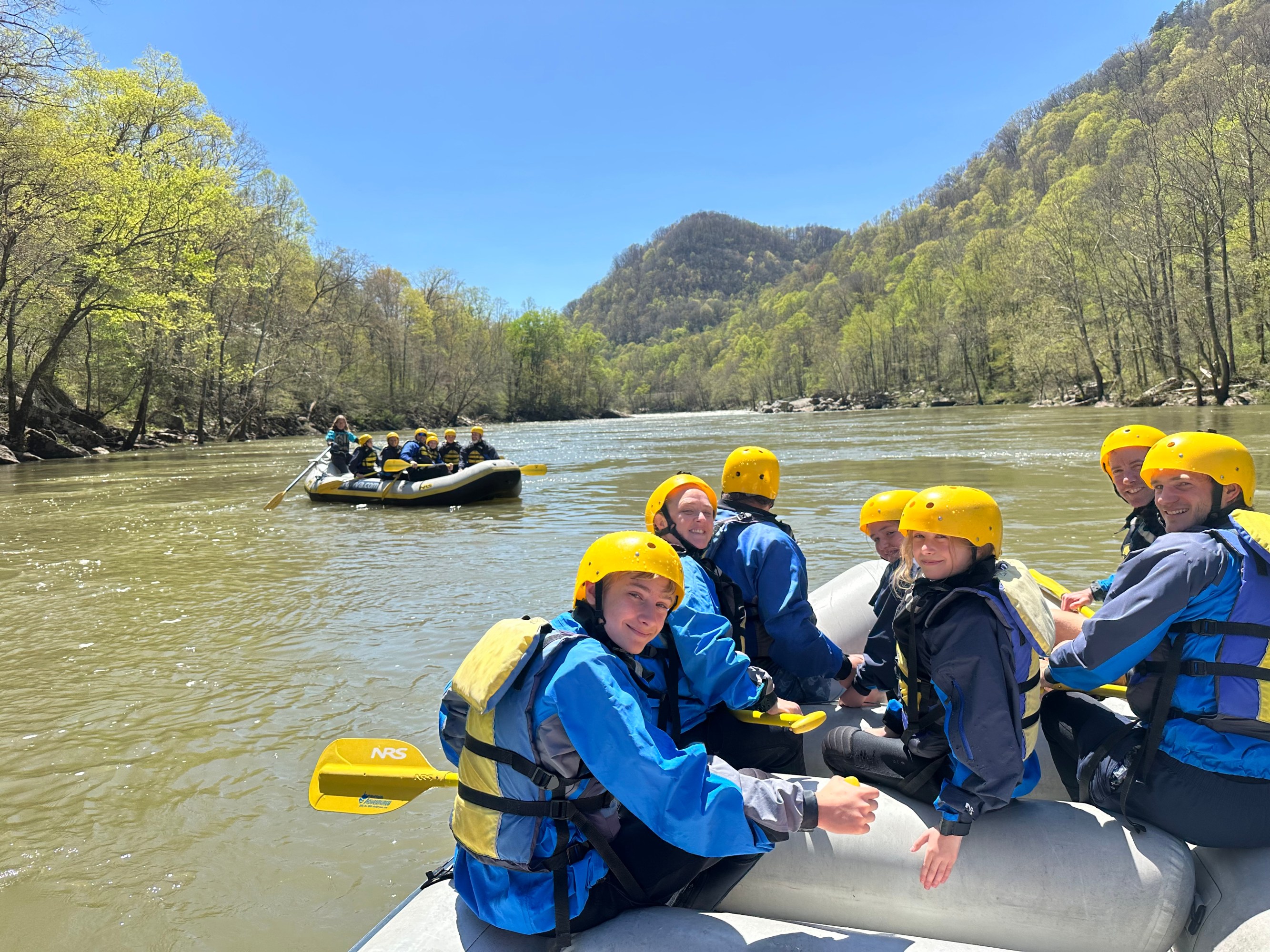 a group of people sitting on a boat in the water
