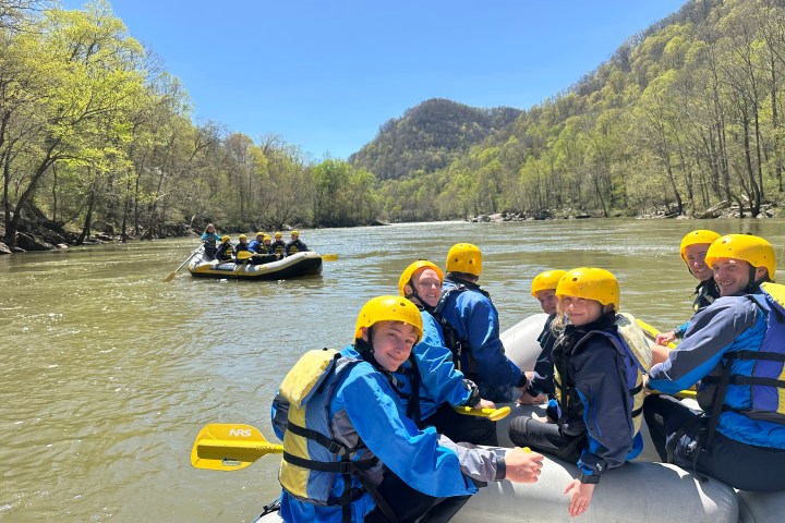 a group of people sitting on a boat in the water